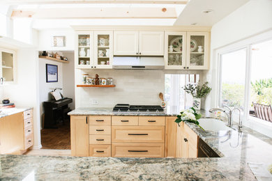 Mid-sized transitional u-shaped vinyl floor and multicolored floor eat-in kitchen photo in San Diego with a double-bowl sink, recessed-panel cabinets, light wood cabinets, granite countertops, white backsplash, subway tile backsplash, stainless steel appliances, a peninsula and blue countertops