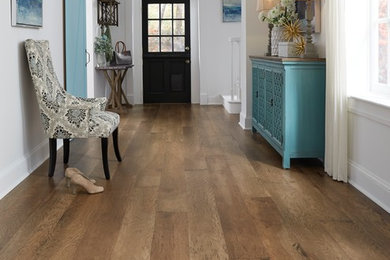 Example of a large transitional medium tone wood floor and brown floor hallway design in Philadelphia with white walls