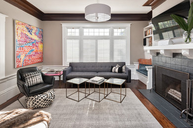 Example of a mid-sized 1960s enclosed dark wood floor living room design in San Francisco with gray walls, a wall-mounted tv, a standard fireplace and a tile fireplace