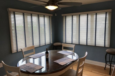 Trendy beige floor dining room photo in New York with blue walls and no fireplace