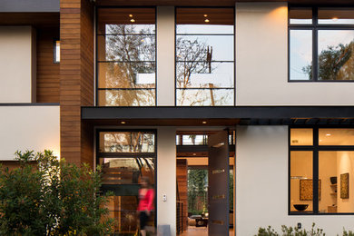Photo of a contemporary two-storey house exterior in San Francisco with mixed siding and a flat roof.