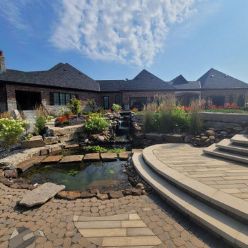 Estate Poolside Landscape & Hardscape Retreat with Custom Waterfeature