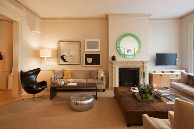 Mid-sized minimalist open concept medium tone wood floor living room photo in New York with a standard fireplace, a wall-mounted tv, beige walls and a plaster fireplace