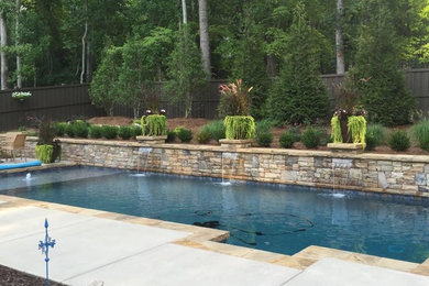 Pool fountain - large transitional backyard concrete and rectangular pool fountain idea in Atlanta