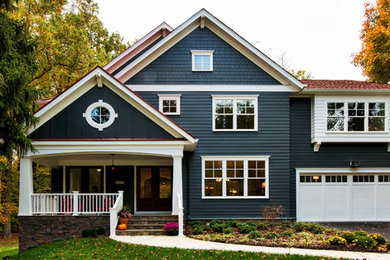 Example of a large arts and crafts blue two-story wood exterior home design in DC Metro