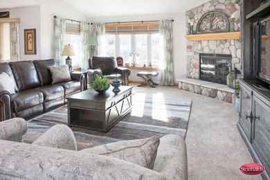 Inspiration for a large rustic open concept carpeted and gray floor family room remodel in Milwaukee with gray walls, a corner fireplace, a stone fireplace and a tv stand