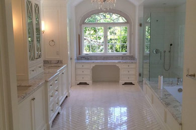 This is an example of a large traditional master bathroom in Los Angeles with shaker cabinets, white cabinets, an alcove tub, an open shower, white tile, subway tile, white walls, marble floors, an undermount sink and marble benchtops.