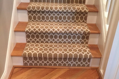 This is an example of a mid-sized traditional wood straight staircase in Other with painted wood risers and wood railing.