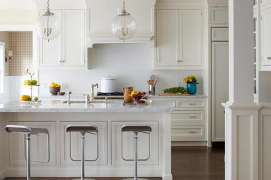 Example of a mid-sized trendy single-wall dark wood floor and brown floor kitchen design in Other with shaker cabinets, white cabinets, marble countertops, white backsplash, paneled appliances and an island