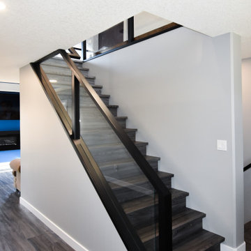 Hand stained stair rail with glass panels