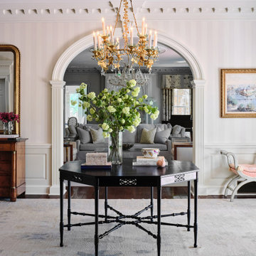 Wallpapered entry foyer in a European-inspired traditional home