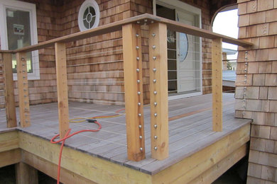 Example of a mid-sized trendy brown one-story wood exterior home design in Other