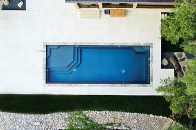 Pool - modern backyard stone and rectangular natural pool idea in Austin