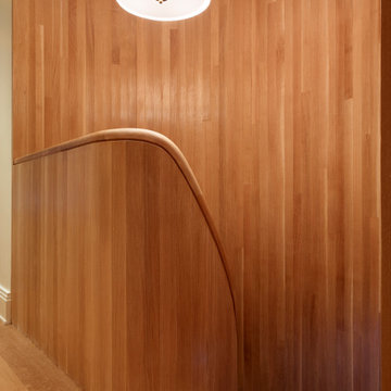 On the upper level, the railing smoothly transitions into the inner handrail