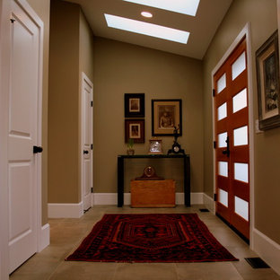 Exemple d'un grand hall d'entrée éclectique avec un mur vert, un sol en carrelage de céramique, une porte double et une porte en bois brun.