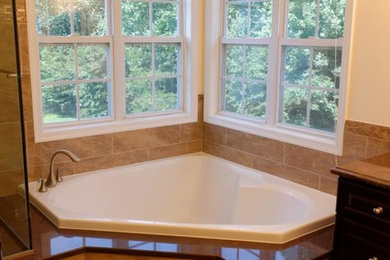 Inspiration for a large timeless master beige tile and porcelain tile porcelain tile bathroom remodel in DC Metro with an undermount sink, raised-panel cabinets, dark wood cabinets, granite countertops and white walls