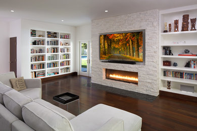 Photo of a mid-sized contemporary open concept family room in Los Angeles with white walls, dark hardwood floors, a ribbon fireplace, a stone fireplace surround, a library, a built-in media wall and brown floor.