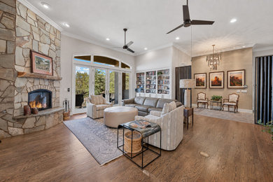 Southwest wallpaper living room photo in Phoenix with gray walls, a corner fireplace and a stone fireplace