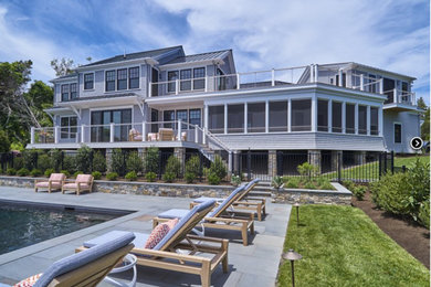 Example of a house exterior design in Boston with a metal roof and a black roof