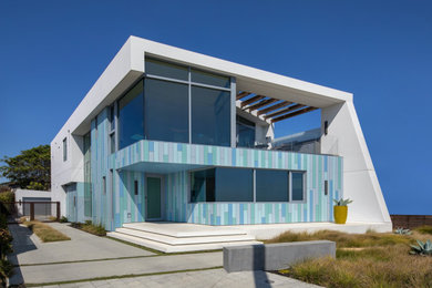 Large and multi-coloured modern two floor detached house in San Francisco with a white roof.