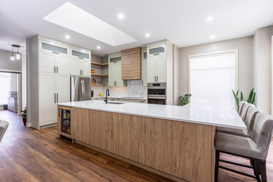 Large kitchen photo in Calgary with shaker cabinets, medium tone wood cabinets and an island