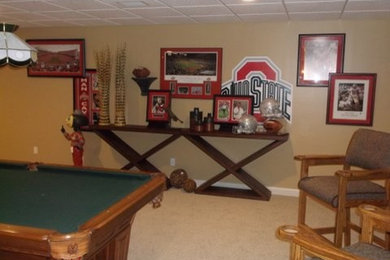 Example of a large mountain style underground carpeted basement design in Other with beige walls, a standard fireplace and a brick fireplace