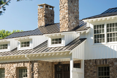 Example of a large country white two-story mixed siding house exterior design in DC Metro with a metal roof and a black roof