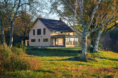 Inspiration for a mid-sized contemporary two-story wood exterior home remodel in Boston with a shingle roof