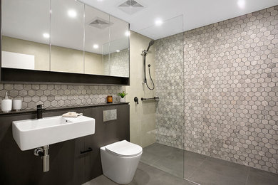 This is an example of a contemporary bathroom in Sydney with an open shower, a one-piece toilet, gray tile, porcelain tile, grey walls, porcelain floors, a vessel sink, engineered quartz benchtops and an open shower.
