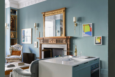 Design ideas for a small classic kitchen in London with an integrated sink, recessed-panel cabinets, blue cabinets, composite countertops, white splashback, medium hardwood flooring, an island and white worktops.