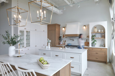 Kitchen - large country kitchen idea in Montreal with shaker cabinets, white cabinets, solid surface countertops, white backsplash, stone slab backsplash and two islands