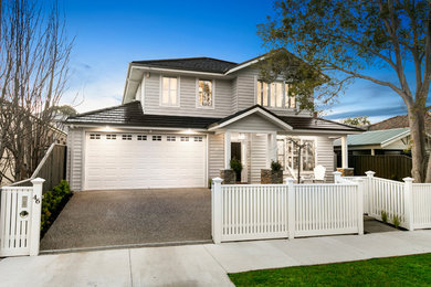 This is an example of a large transitional two-storey grey house exterior in Melbourne with wood siding, a gable roof and a tile roof.