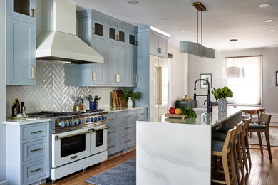 Transitional medium tone wood floor eat-in kitchen photo in DC Metro with shaker cabinets, blue cabinets, white backsplash, white appliances, an island and white countertops