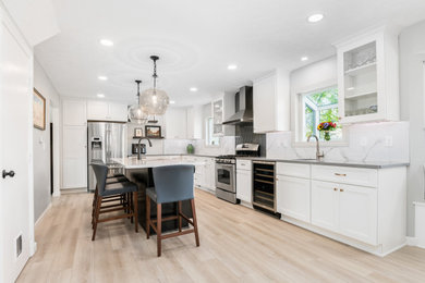 Eat-in kitchen - large modern l-shaped eat-in kitchen idea in Philadelphia with quartz countertops and an island