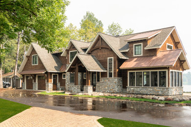 Large mountain style brown two-story exterior home photo in Minneapolis with a shingle roof and a brown roof