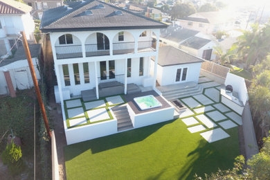 Example of a large white two-story house exterior design in Los Angeles with a shingle roof