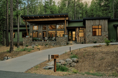 Rustic multicolored two-story mixed siding house exterior idea in Other with a shed roof