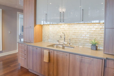 Kitchen - transitional medium tone wood floor kitchen idea in Boston with an undermount sink, quartz countertops, an island, flat-panel cabinets, white backsplash, subway tile backsplash and colored appliances