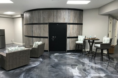 Example of a large trendy underground gray floor basement design in Miami with gray walls