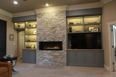 Living room - mid-sized contemporary open concept carpeted and beige floor living room idea in Austin with beige walls, a ribbon fireplace, a stone fireplace and a media wall