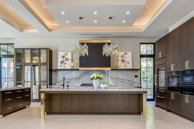 Inspiration for a large contemporary u-shaped limestone floor, beige floor and tray ceiling eat-in kitchen remodel in Orange County with marble countertops, a drop-in sink, flat-panel cabinets, medium tone wood cabinets, gray backsplash, stone slab backsplash, black appliances, two islands and gray countertops