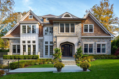 Example of a transitional stone house exterior design in New York