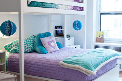 Design ideas for a mid-sized traditional kids' bedroom for kids 4-10 years old and girls in New York with white walls, medium hardwood floors and brown floor.