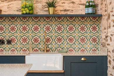 Inspiration for a transitional kitchen in London with cement tile splashback.