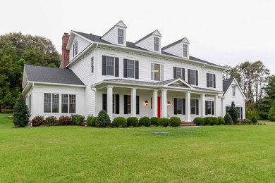 This is an example of a large traditional two-storey white exterior in Baltimore with concrete fiberboard siding and a gable roof.