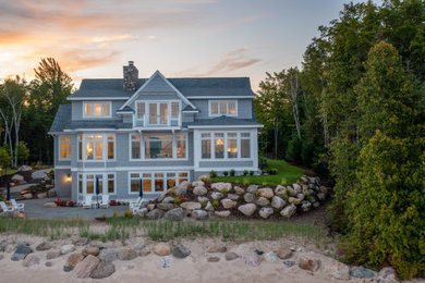 Inspiration for a large timeless gray three-story vinyl and shingle house exterior remodel in Other with a shingle roof and a gray roof