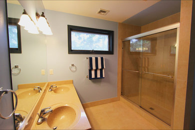 Example of a mid-sized minimalist 3/4 multicolored tile and porcelain tile porcelain tile alcove shower design in Philadelphia with an integrated sink, quartz countertops, a one-piece toilet and blue walls