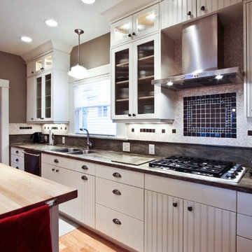 Range hood and backsplash anchor this new, bright kitchen
