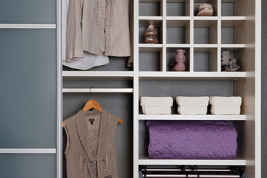 Walk-in closet - mid-sized transitional gender-neutral carpeted and beige floor walk-in closet idea in Charleston with open cabinets and white cabinets