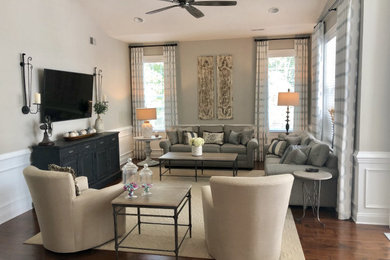Example of a large cottage open concept dark wood floor and brown floor family room design in Philadelphia with gray walls, no fireplace and a wall-mounted tv